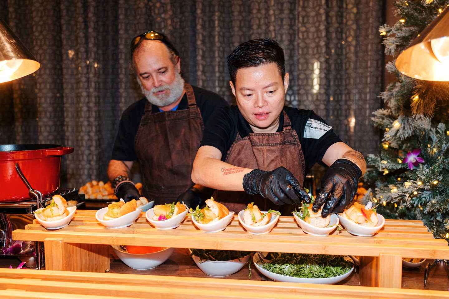 Billy Richmond and and chef Nikki Tran assemble scallop and shrimp banh mi.