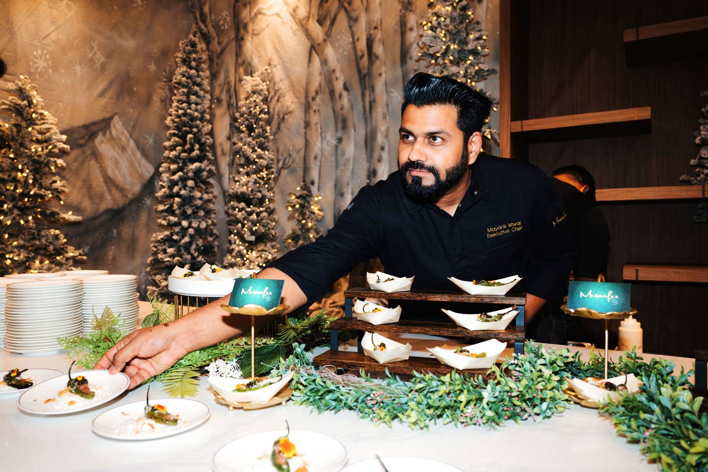 Musaafer chef Mayank Istwal, surrounded by holiday decor, plating stuffed peppers.