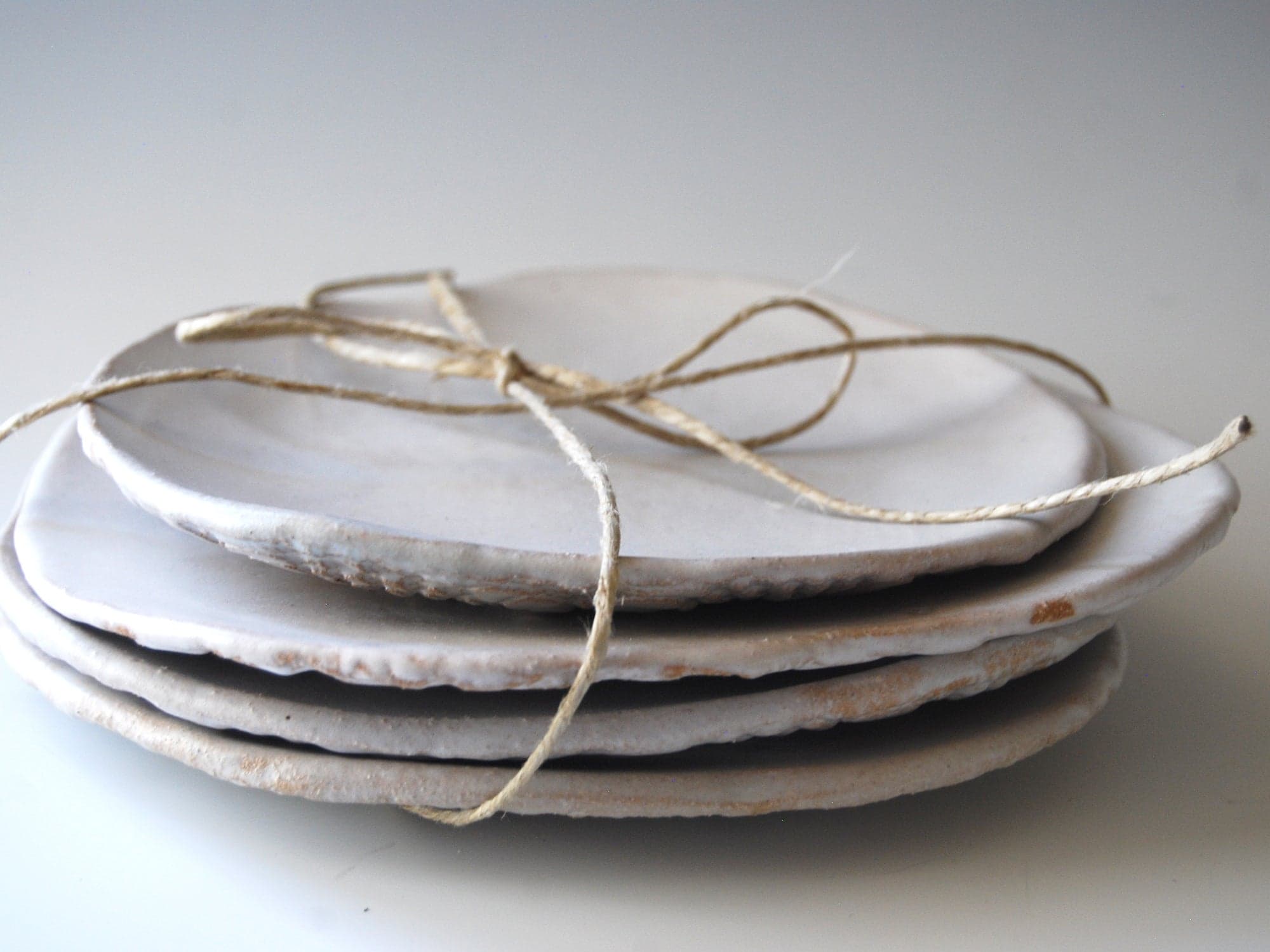 Handmade, artisan white ceramic dessert plates with lace pattern