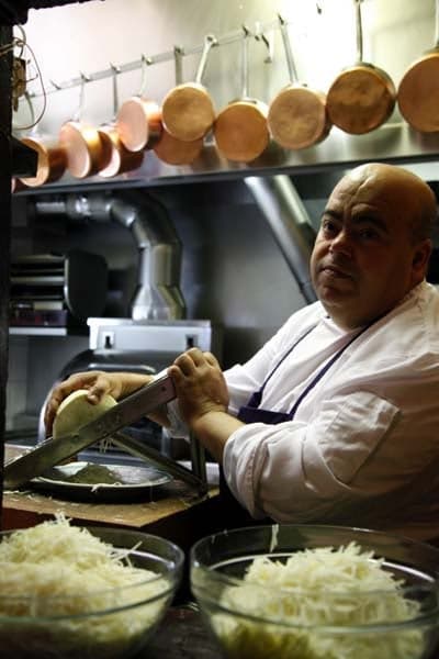 A chef in the kitchen at L'Ami Louis Bistro Paris