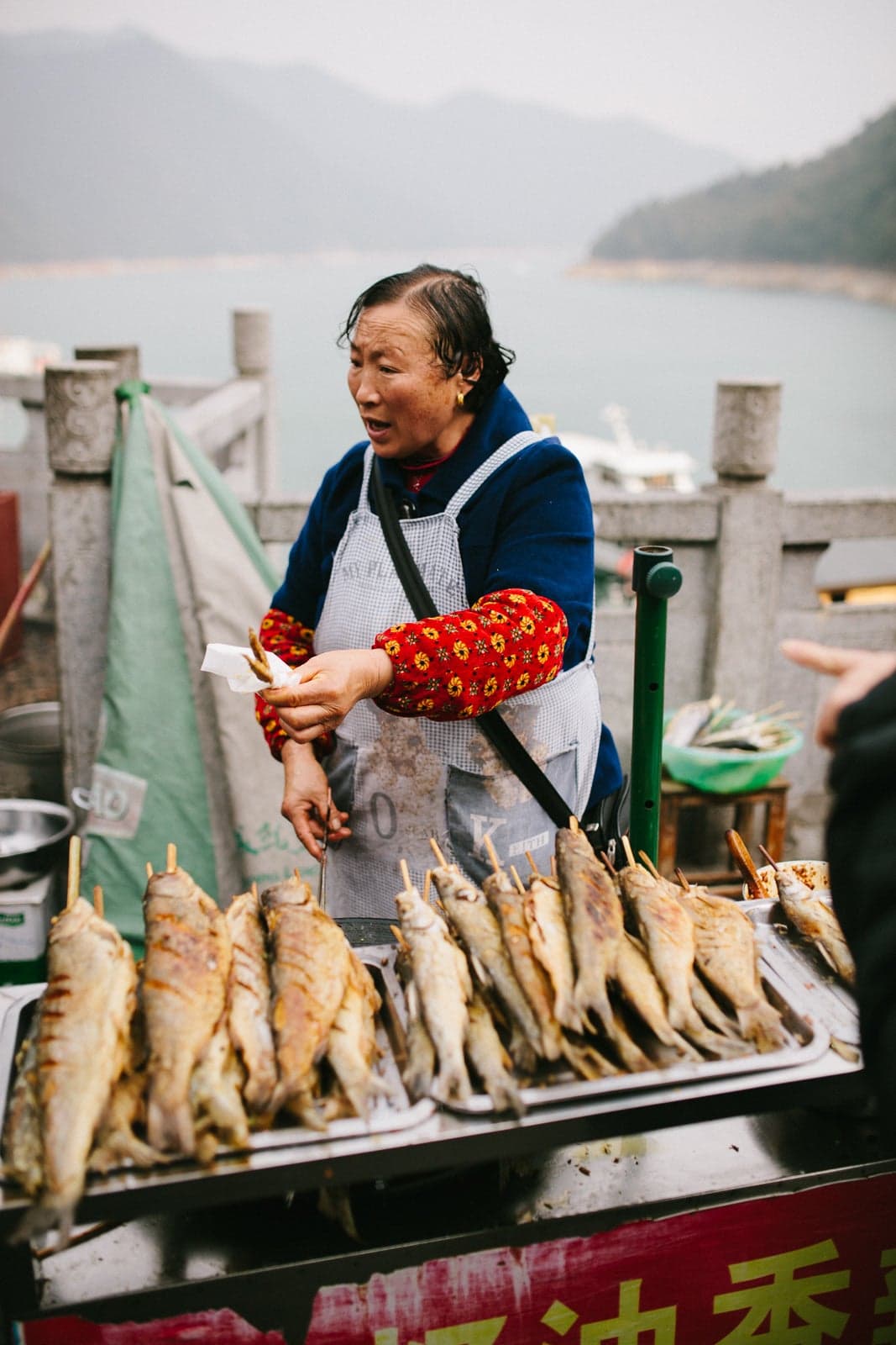 Woman selling fish, China