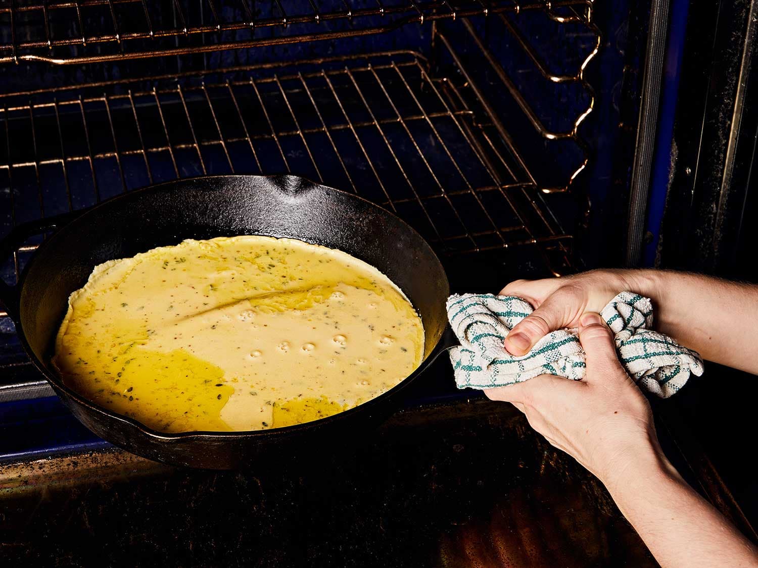 Carefully swirl the farinata batter until it covers the bottom of the skillet.