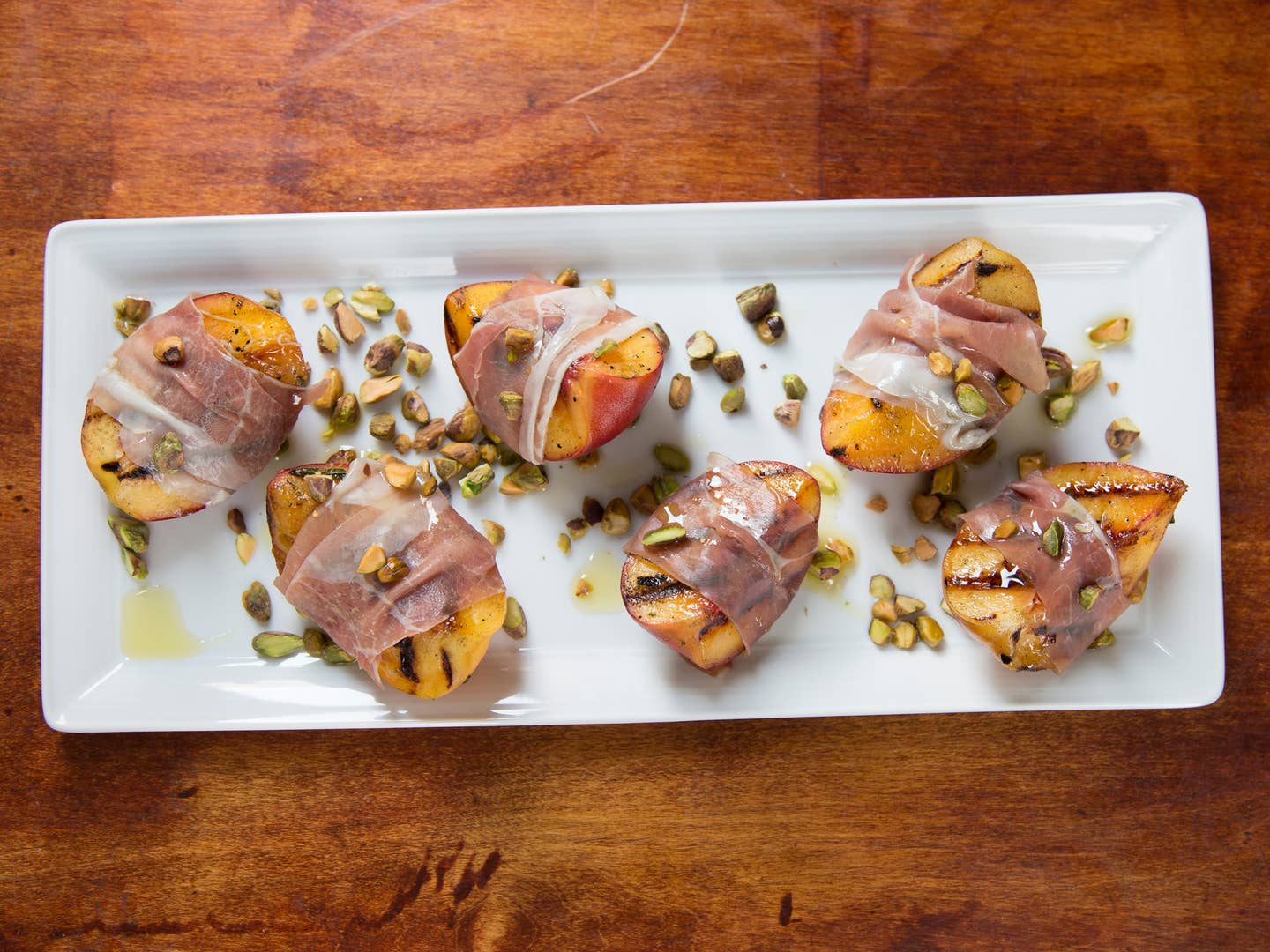 Grilled Peaches with Rosemary, Smoked Country Ham, and Toasted Pistachios