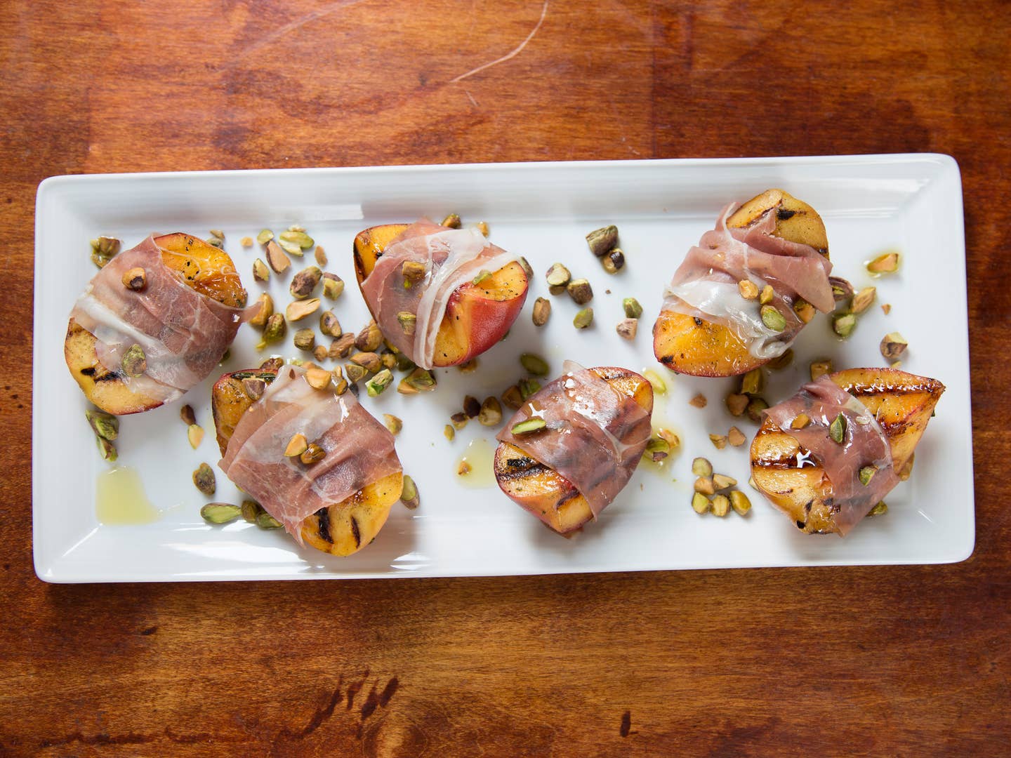 Grilled Peach with Rosemary, Smoked Country Ham, and Toasted Pistachios