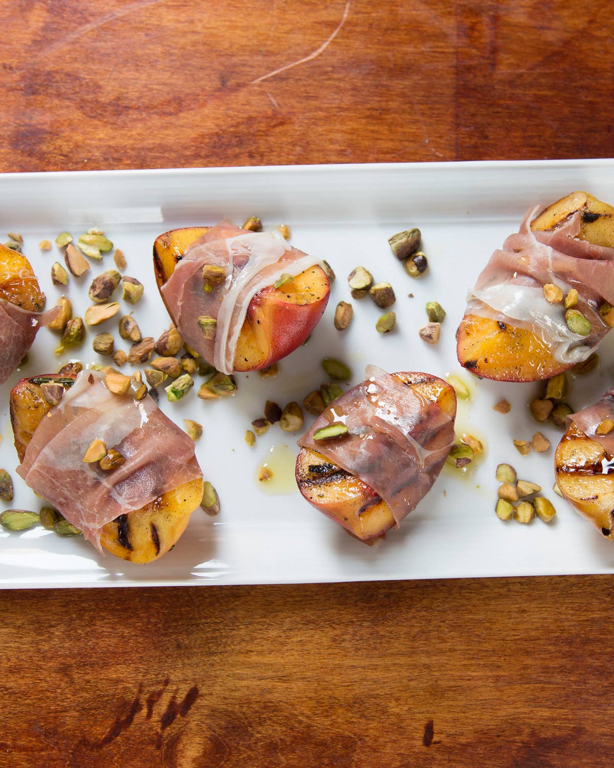 Grilled Peach with Rosemary, Smoked Country Ham, and Toasted Pistachios