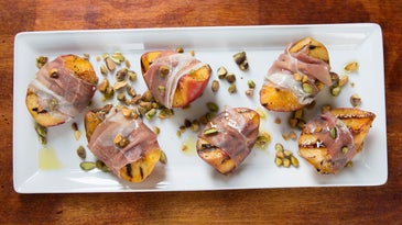 Grilled Peach with Rosemary, Smoked Country Ham, and Toasted Pistachios