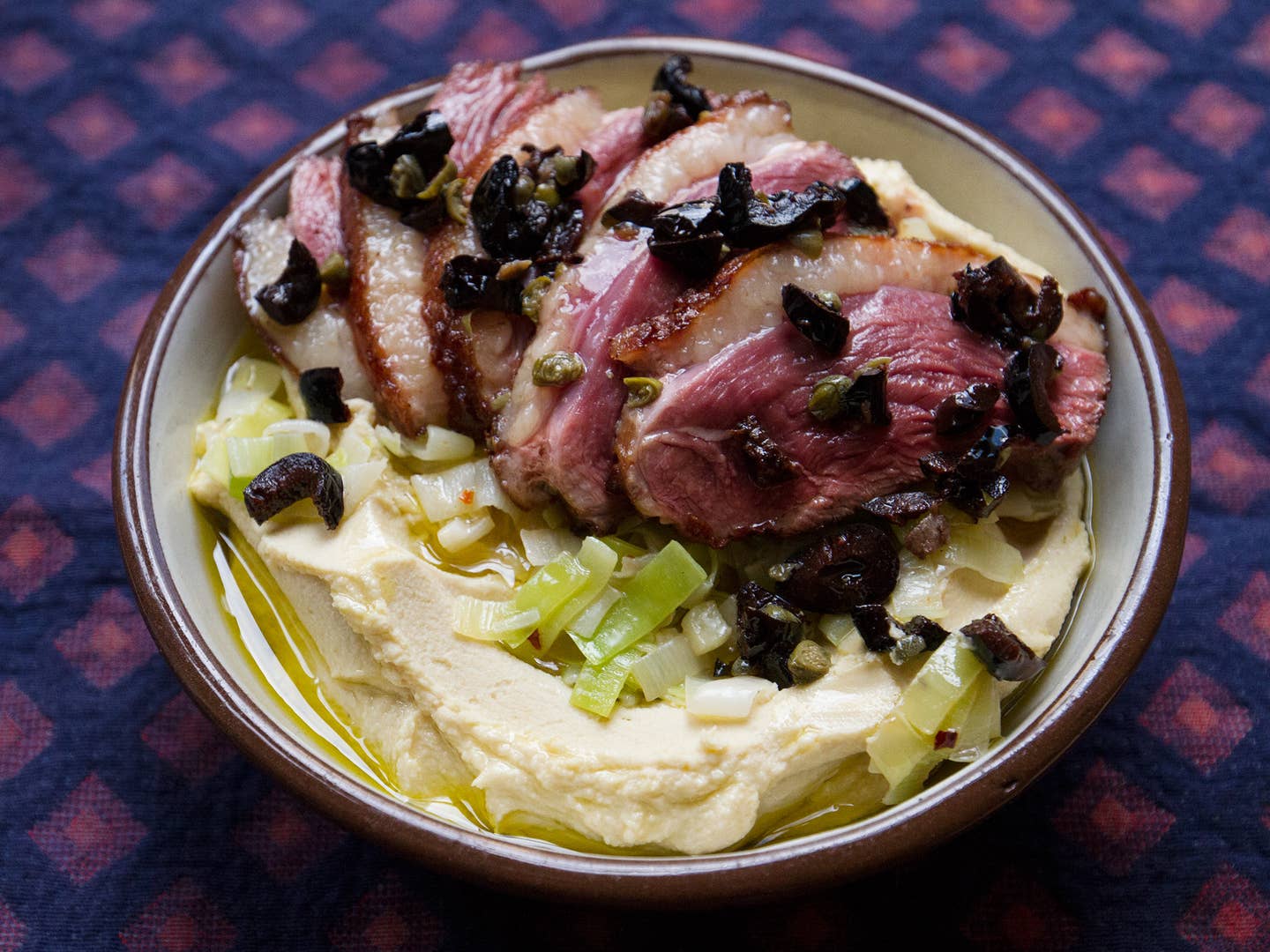 Hummus with Pan-Seared Duck, Leeks, and Tapenade