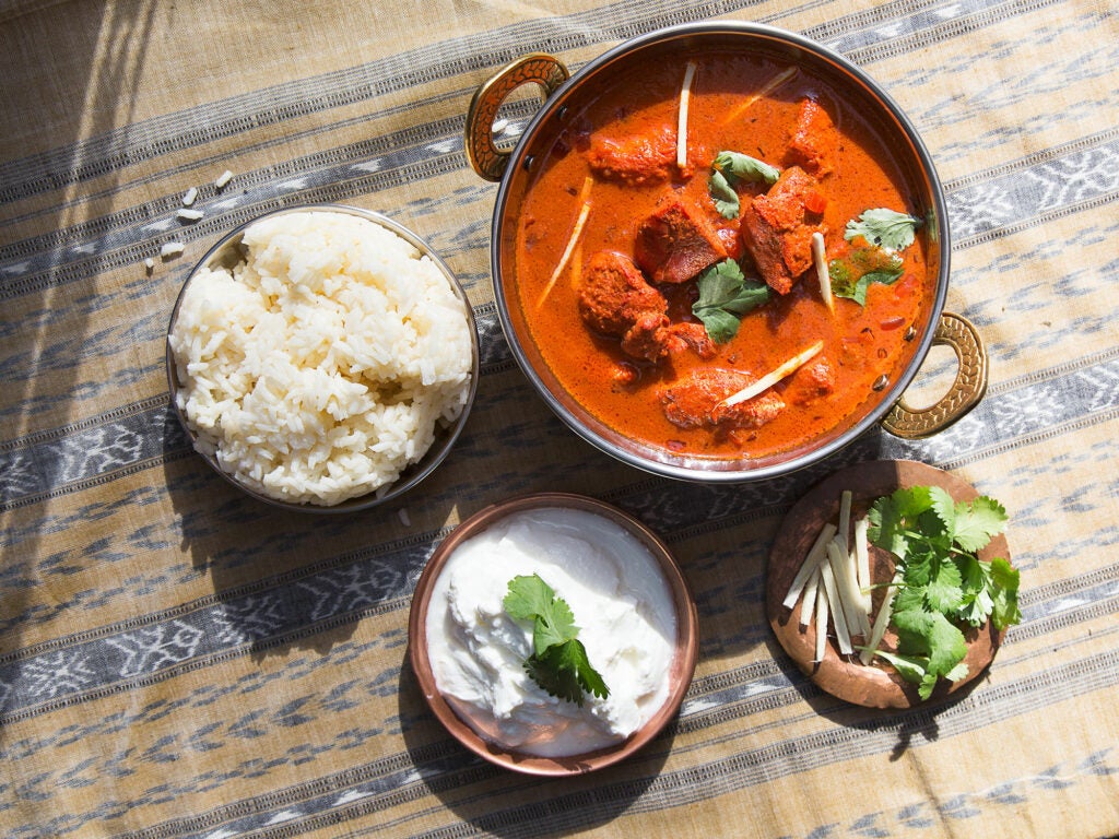 bowl of chicken tikka masala with rice and yogurt