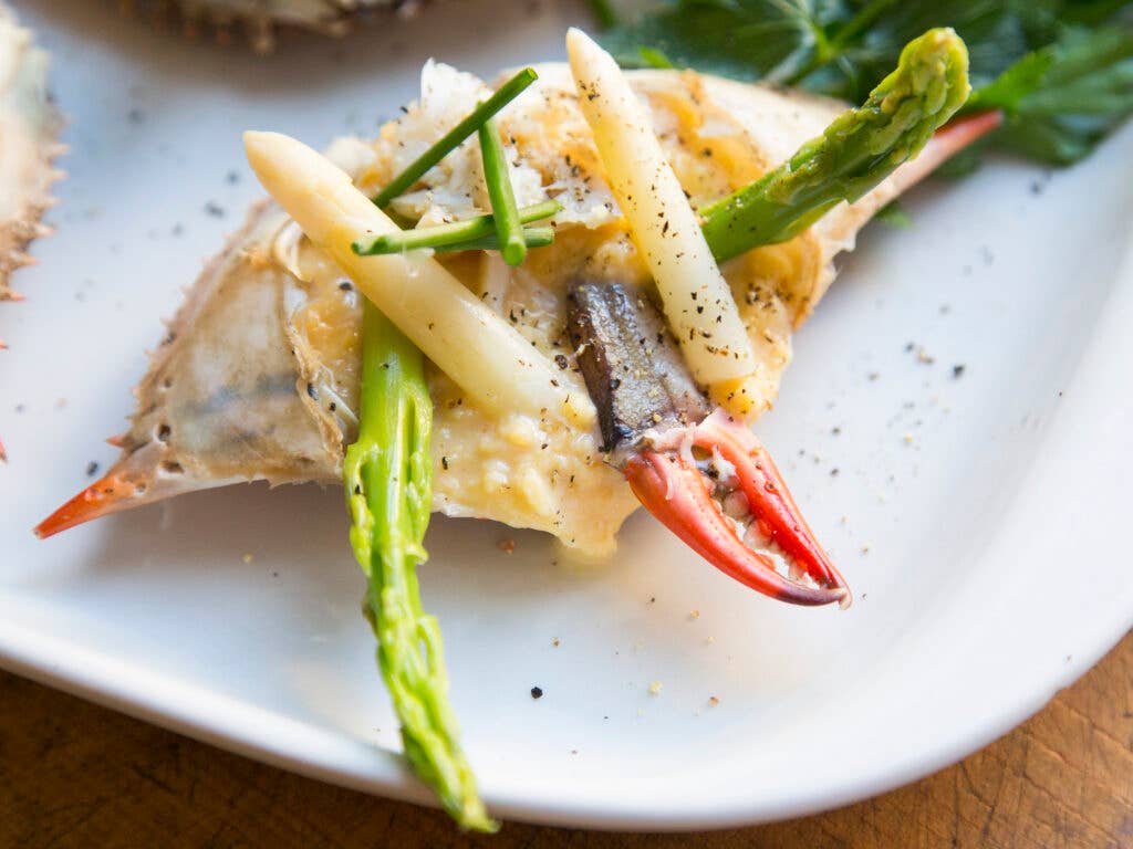 scrambled eggs and asparagus stuffed in crab shells