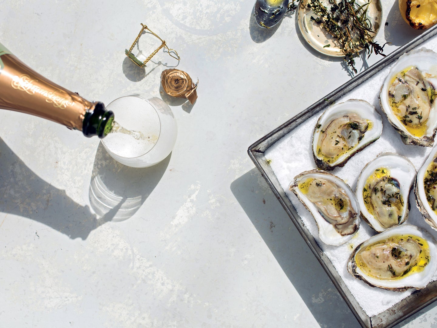 Grilled Oysters on a Bed of Salt with a bottle of Champagne