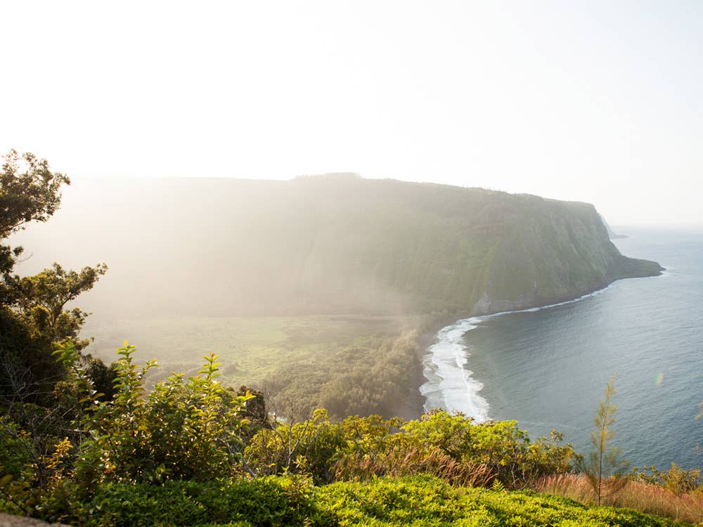 The valley's black sand beach is visible from Waipi'o Overlook