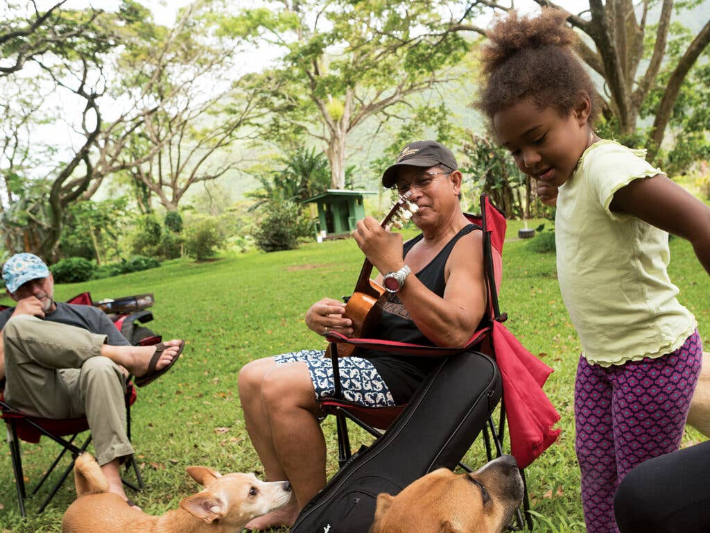 Danny Akaka Jr., the author's friend, entertains extended members of the Mock Chew family (canines included) at a gathering on the Big Island of Hawaii