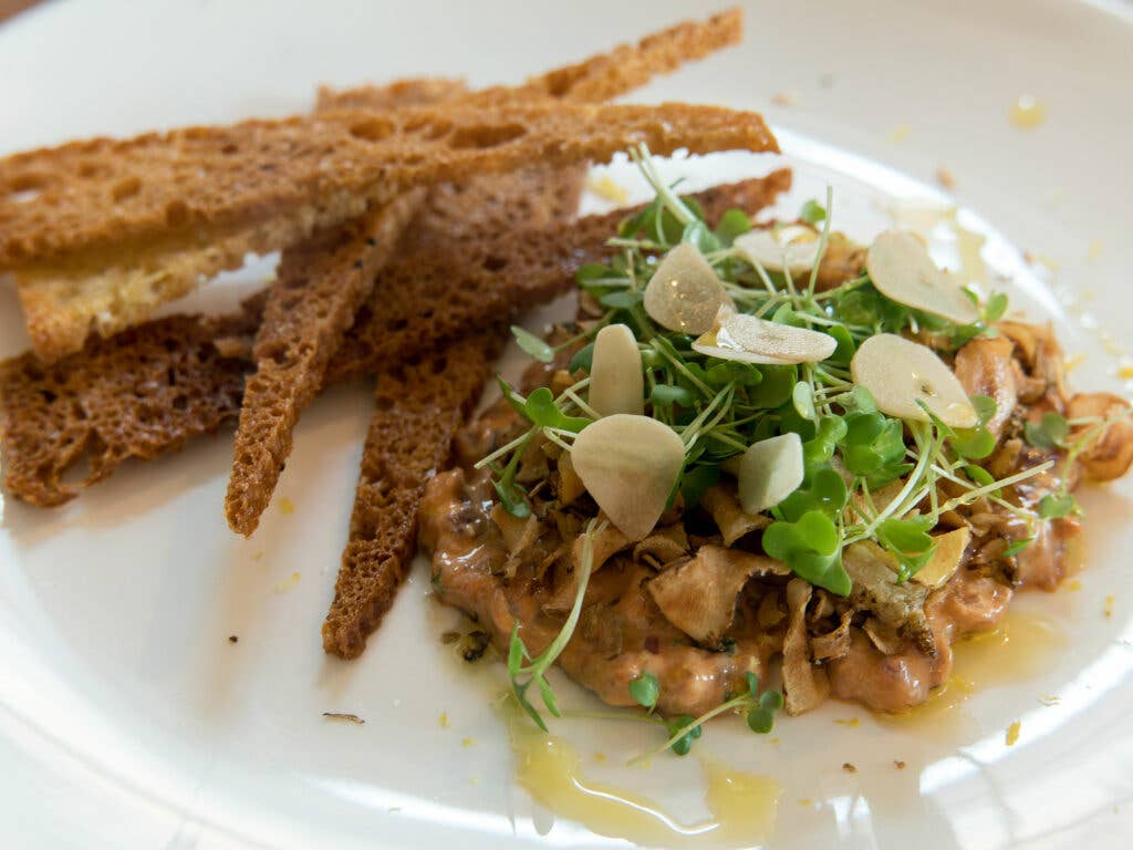 Hand-cut steak tartare with sunchokes, aioli, pickled garlic and crostini at Decca.