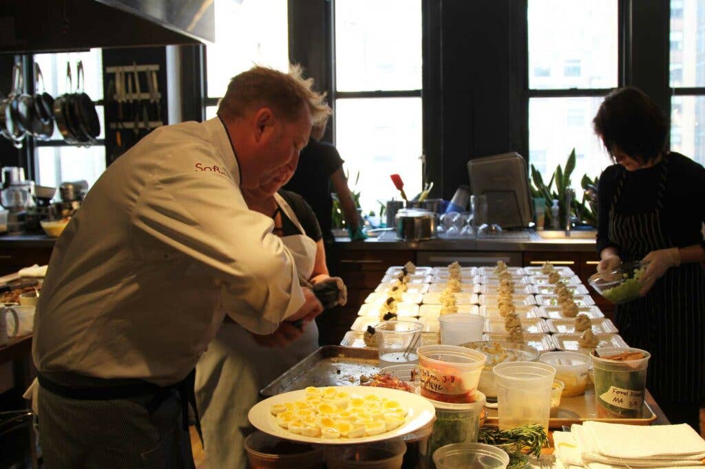 Commander’s Palace head chef Tory McPhail piles caviar on top of seafood sandwiches for the first course.