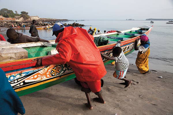 A fishing boat comes ashore at Soumbedioune
