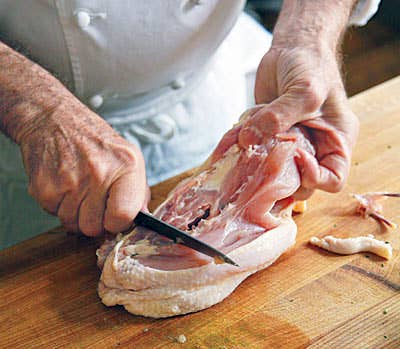 cutting up chicken