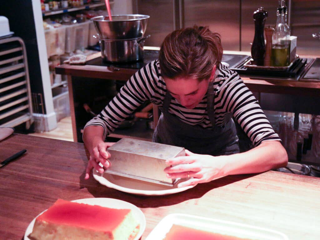 Katie Button flips an egg flan for dessert.