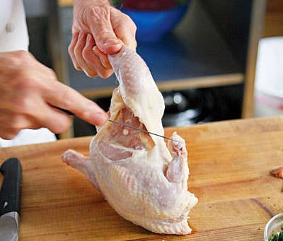 Jacques Pepin cutting up chicken