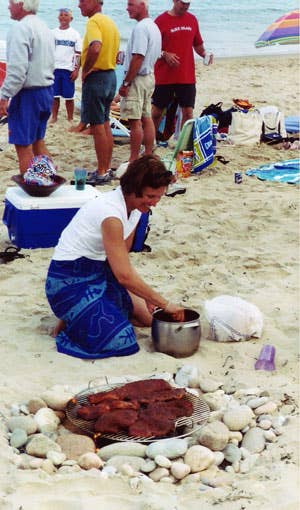 woman grilling on the beach