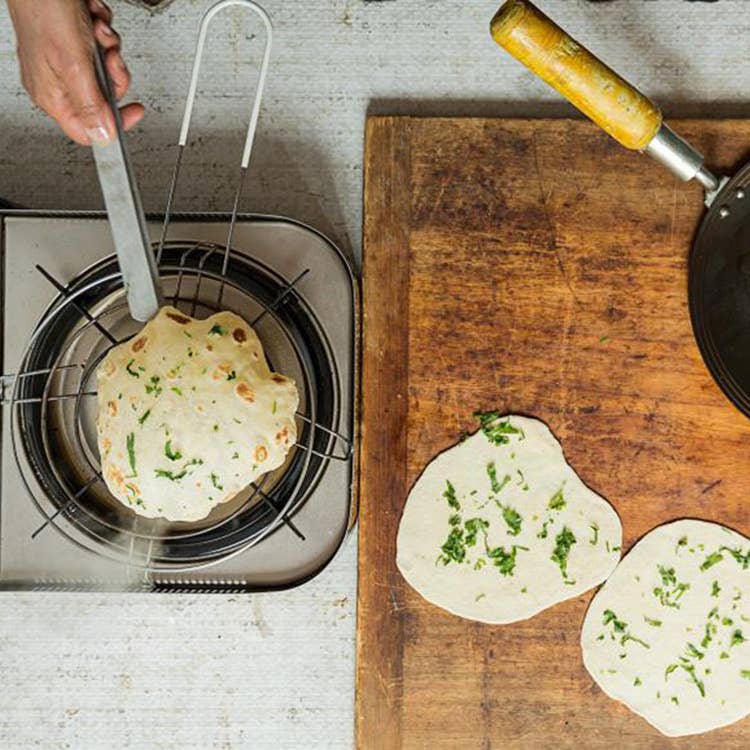 flipping naan bread in pan