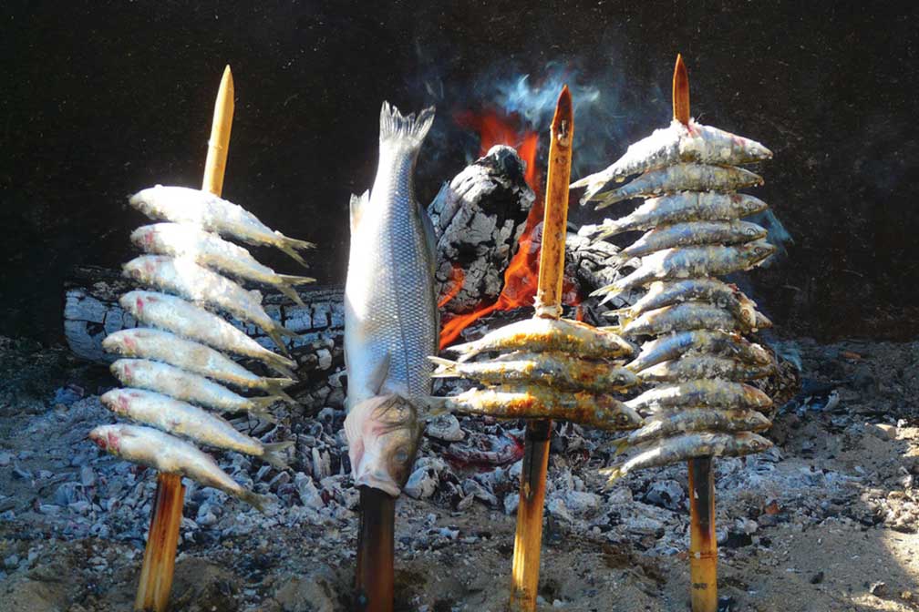 Grilling fish in Marbella, Spain