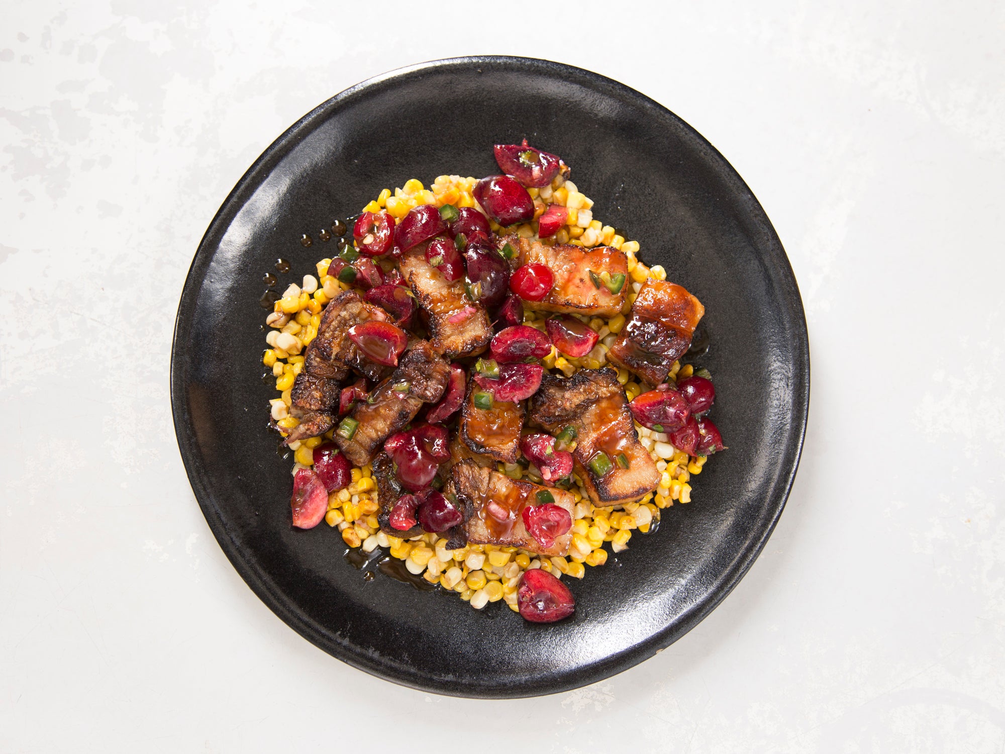 image of Grilled Pork Belly With Buttered Corn and Sour-Sweet Cherry-Jalapeño Relish recipe by Saveur