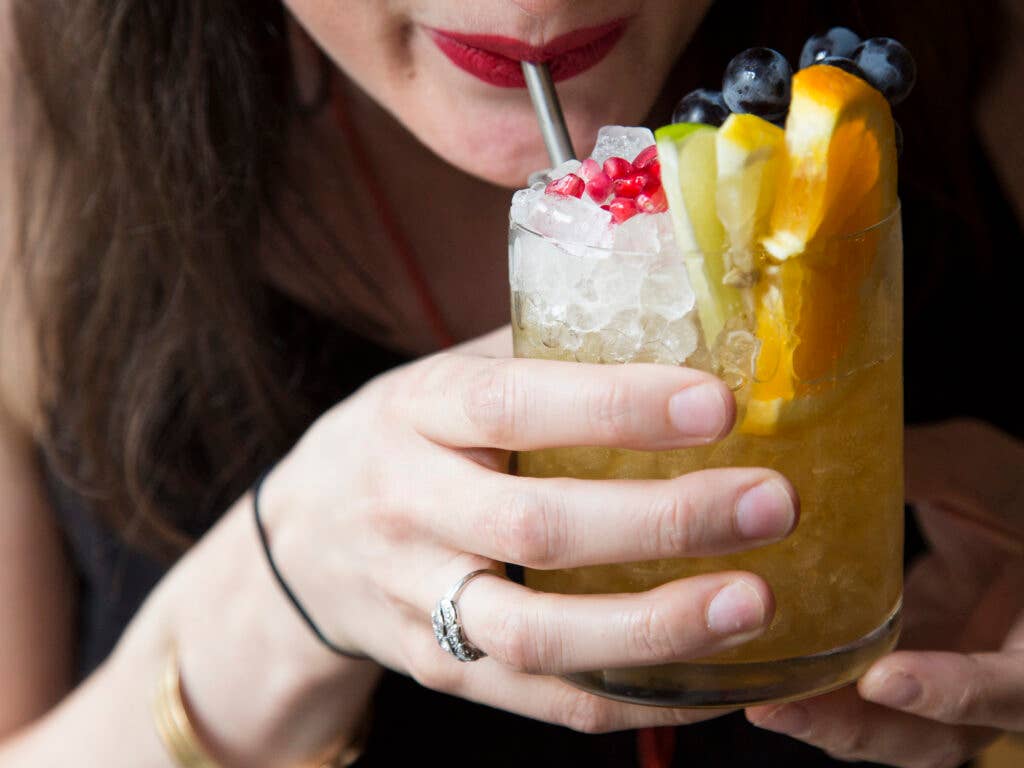 A super-colorful cocktail made with Amaro Nonino, Nonino Moscato grappa, and orange shrub, topped with fresh fruit