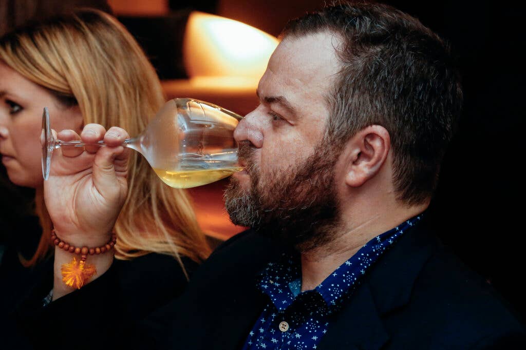 Writer Alex Halberstadt sips a glass of Lynmar Estate chardonnay.