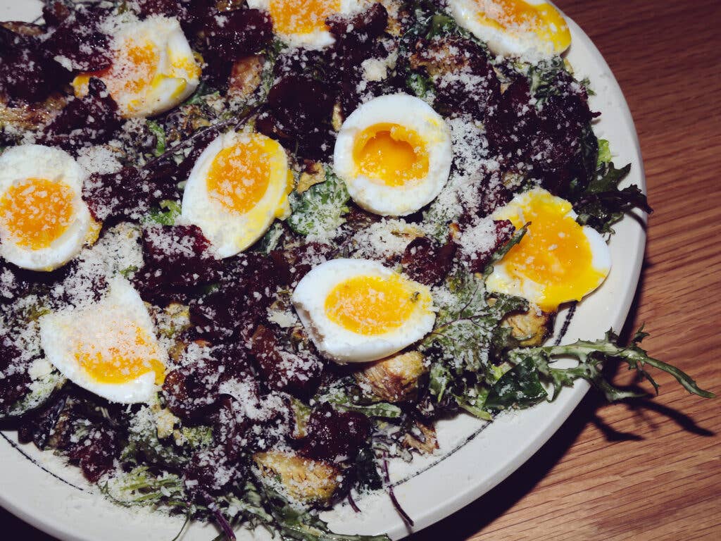 Caesar salad is always better when topped with brussels sprouts, bacon, and some soft eggs