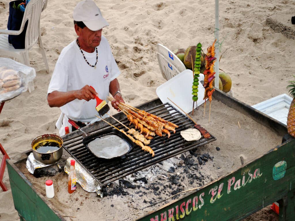 Grilling up a variety of skewers in Puerto Vallarta right on the beach at Playa Los Muertos.