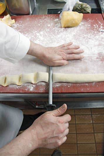 separating dumplings from one another with a paring knife