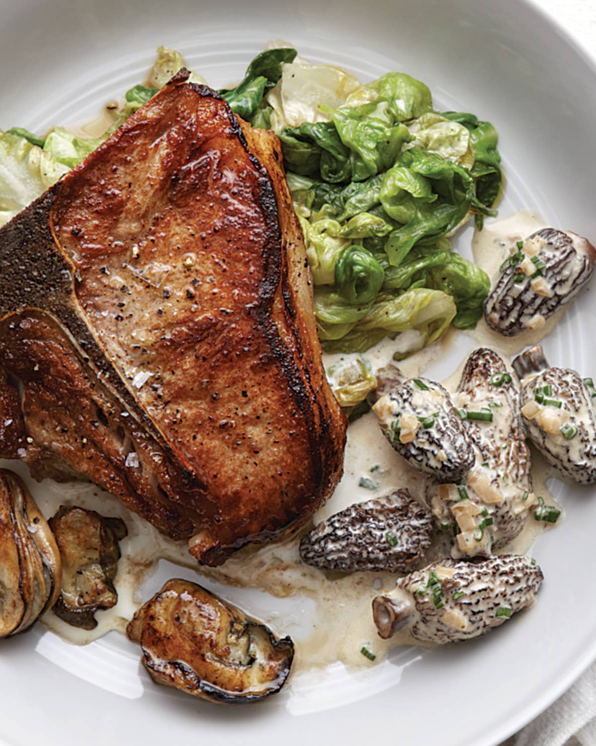 Veal Chops with Morels, Wilted Lettuce, Oysters, and Garlic-Parmesan Sauce