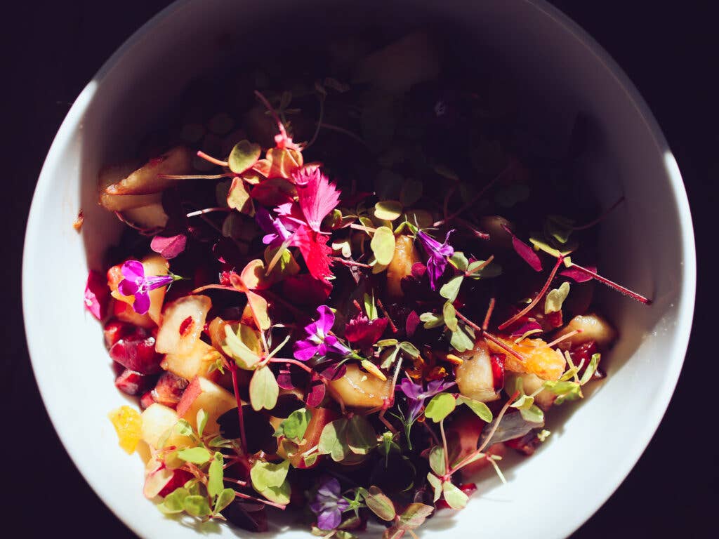 For dessert, fruit and macay root topped with edible flowers