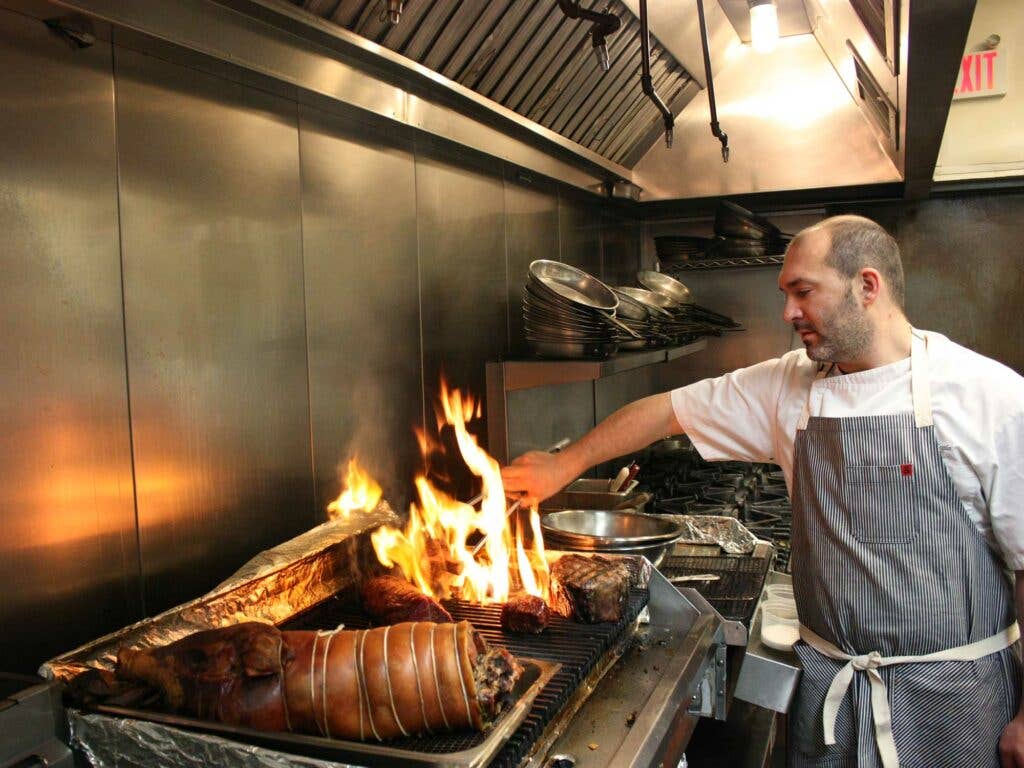 Chef Joe Cicala working just a few of the feast's meat courses