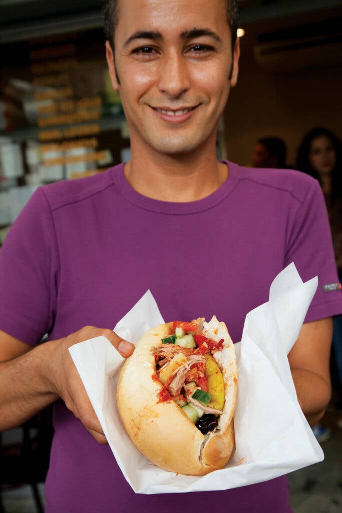 woman holding a tuna sandwich