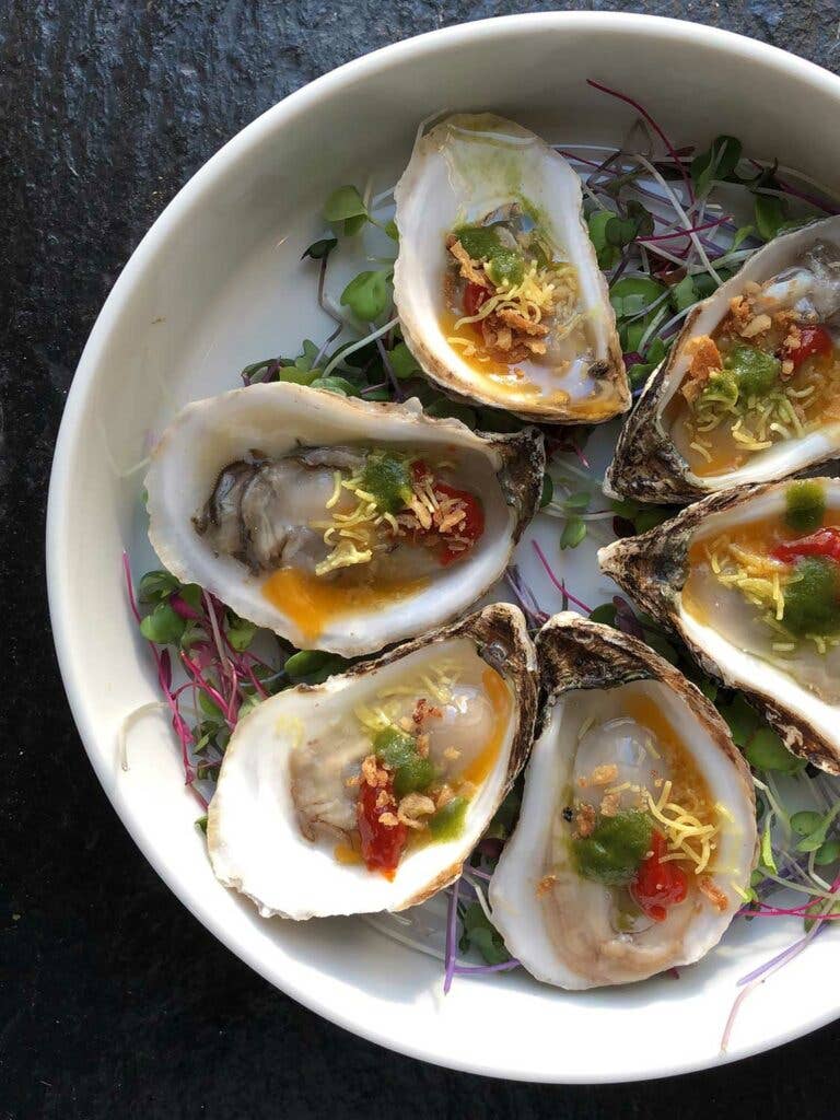 These raw oysters were topped with pickled green mango and sweet-pickled chile.