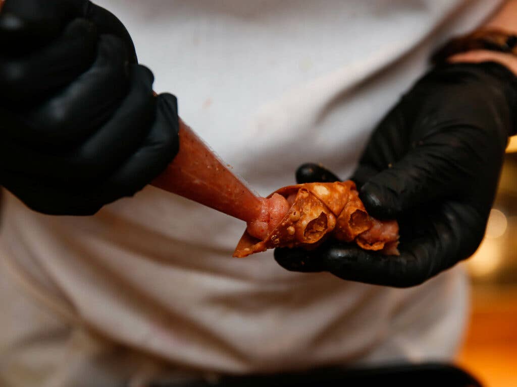 Chef Michael Toscano fills canolis with ciauscolo filling, to be topped with an orange rind mostrada.