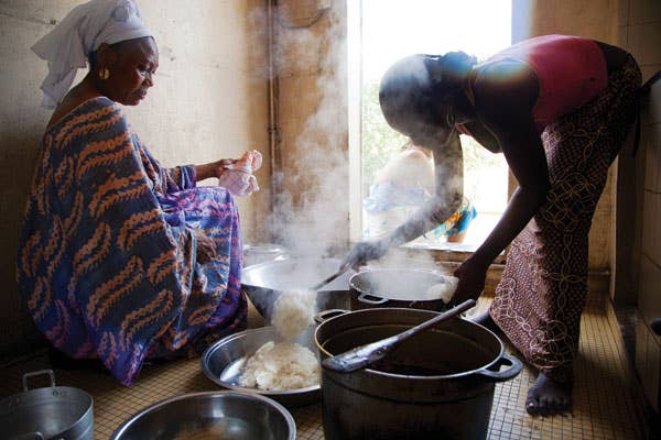 Khady Mbow (left) and her niece Sini prepare a meal at their home in Dakar