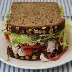 Chicken Salad, Walnuts, Roasted Tomatoes, Pickled Red Onions, and Frisée on Multigrain Bread