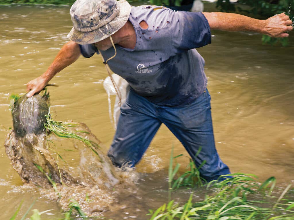 Ricky Crouch catching a turtle