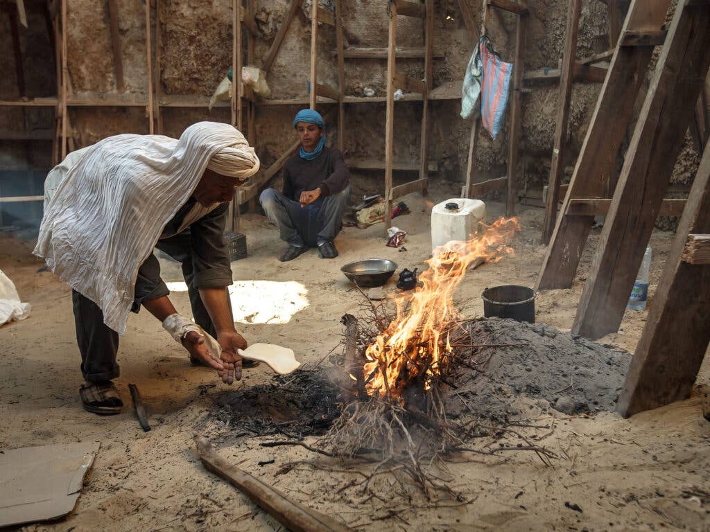 Cooking flatbread on the fire.