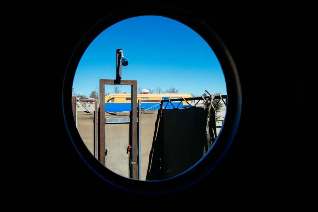 These porthole windows look out to the outdoor shower
