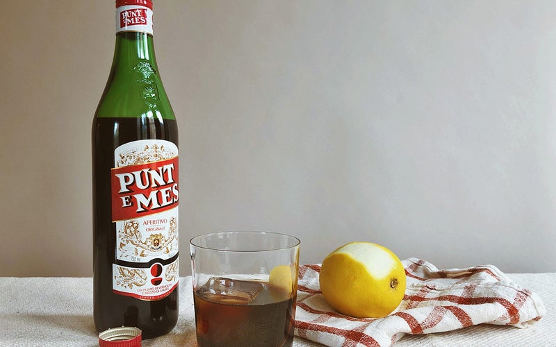 Punt e Mes on table with lemon