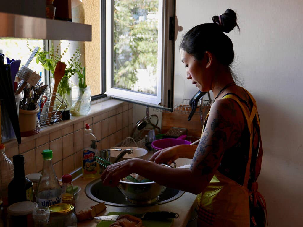 Kim Kim Dao prepping pho in her kitchen