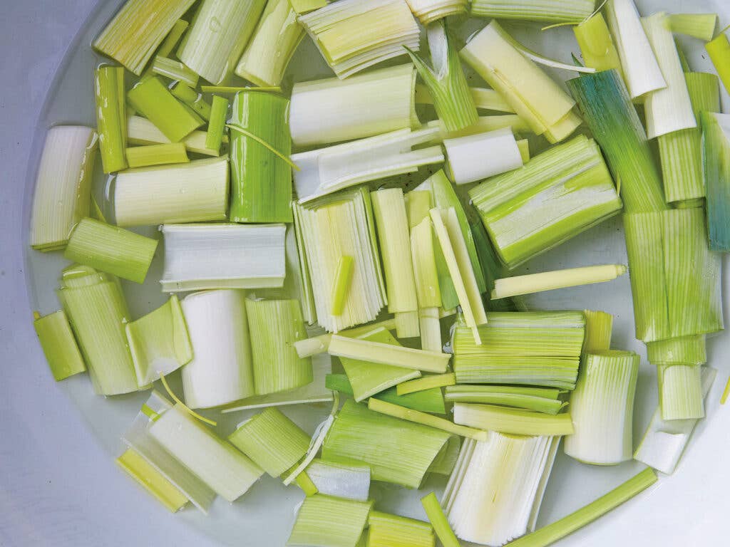 Leeks soaking in a pot of water