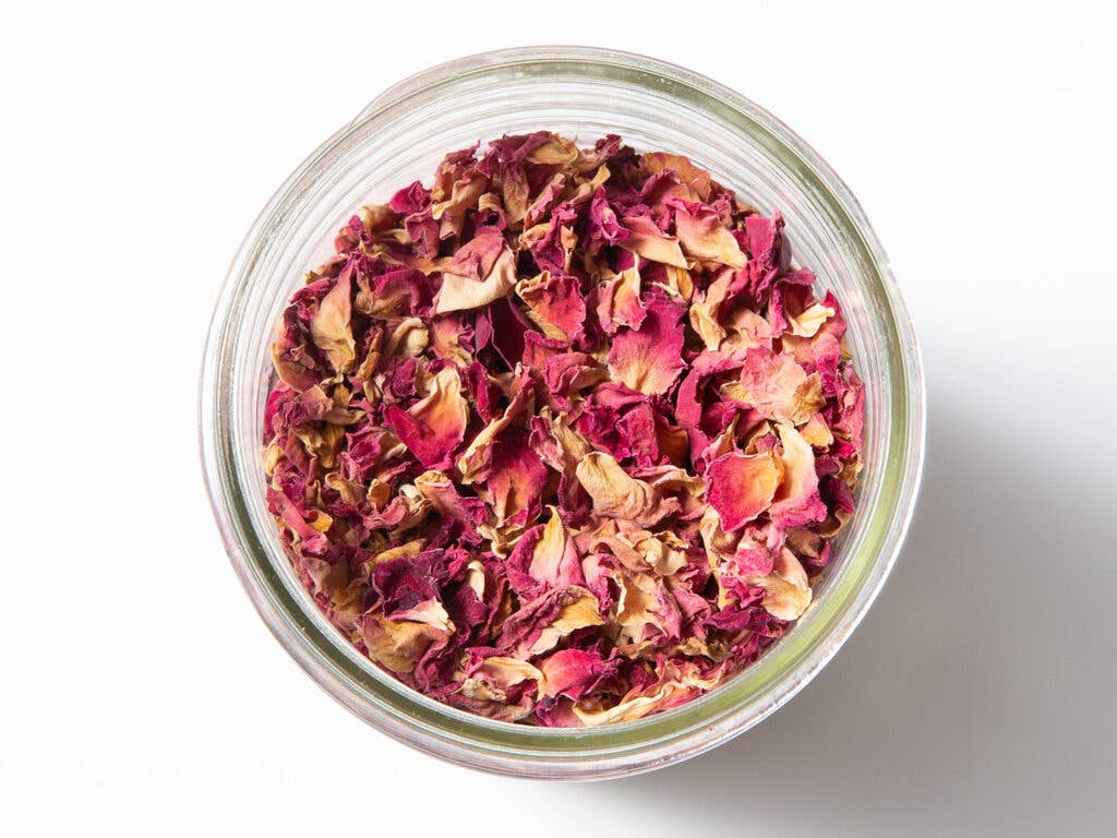 dried rose petals in a glass bowl