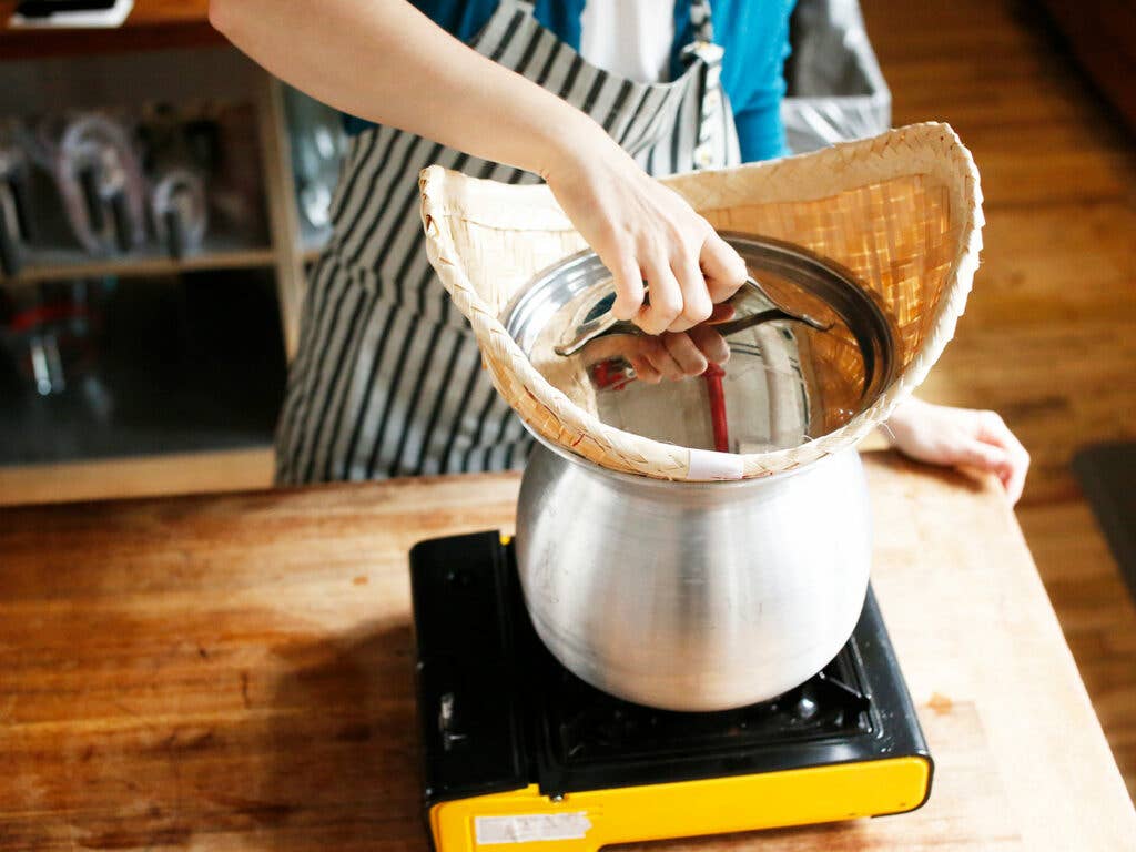 steaming rice with lid over basket