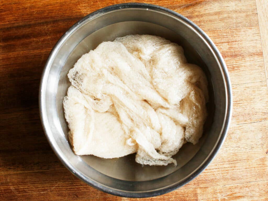 cheesecloth soaking in metal bowl