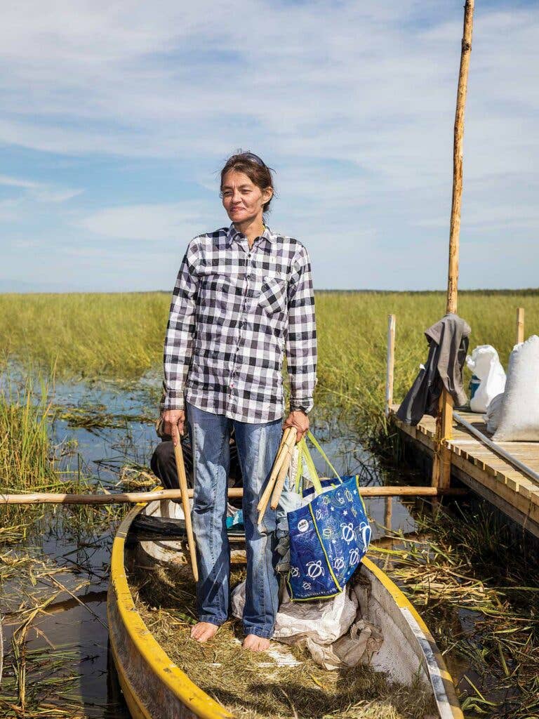 A harvester returns from Little Elbow Lake with a sack of wild rice.