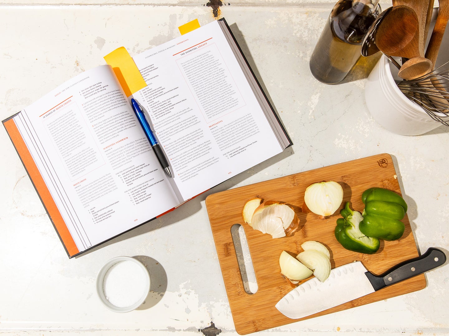 open cookbook with veggies on the cutting board